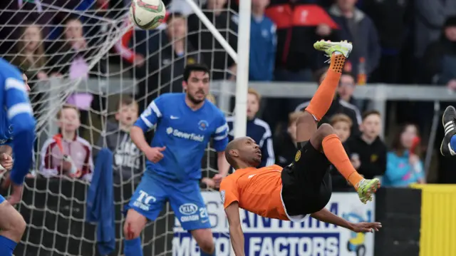 Miguel Chines' overhead kick in injury-time secured Carrick Rangers' place in the top flight