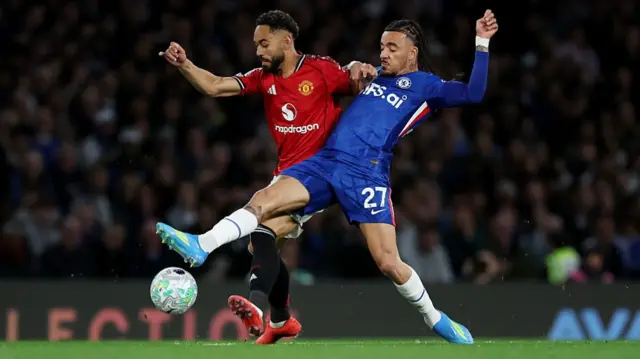 Matheus Cunha of Manchester United battles for possession with Malo Gusto of Chelsea
