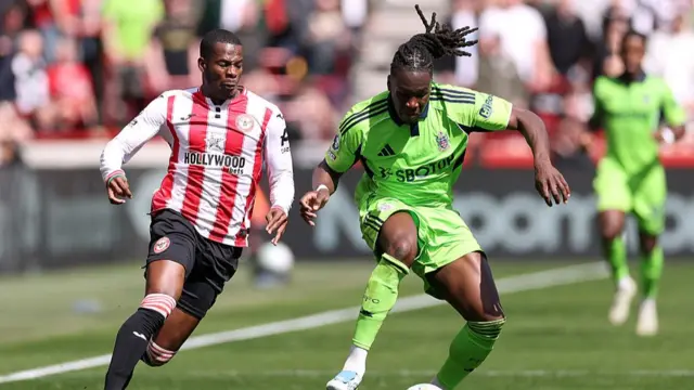 Calvin Bassey of Fulham is challenged by Dango Ouattara of Brentford