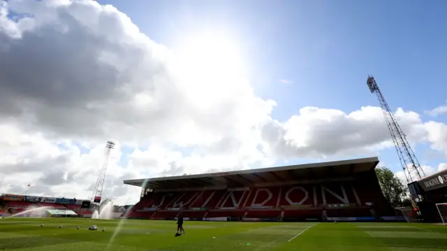 A general view of the County Ground before Swindon v Accrington with the sun shining brightly through dotted clouds in a blue sky