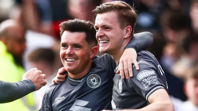 MK Dons players celebrate
