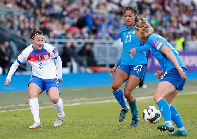 Lucy Bronze hits it into an Iceland defender's legs