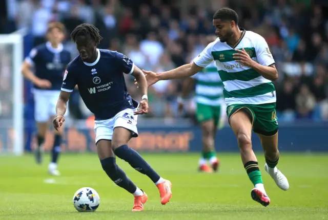 Millwall's Derek Mazou-Sacko (left) and Queens Park Rangers' Jonathan Varane battle for the ball