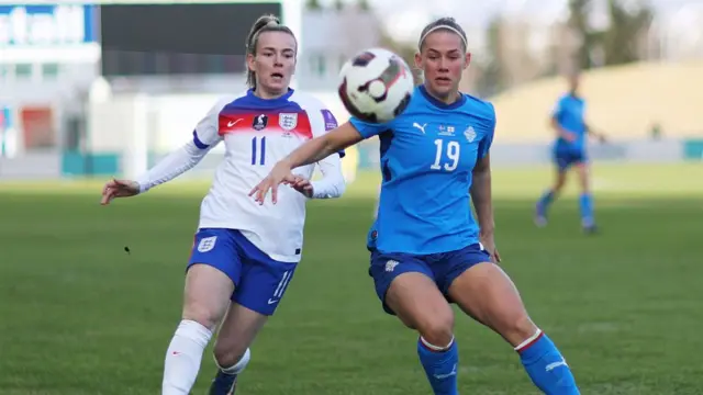 Saedis Heidarsdottir of Iceland is put under pressure by Lauren Hemp