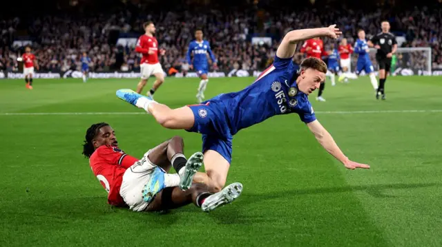 Ayden Heaven of Manchester United clashes with Liam Delap