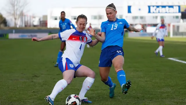Keira Walsh of England is challenged by Saedis Heidarsdottir