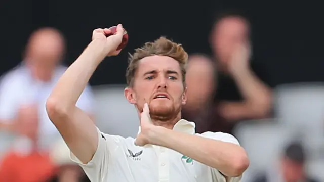 George Balderson bowling for Lancashire.