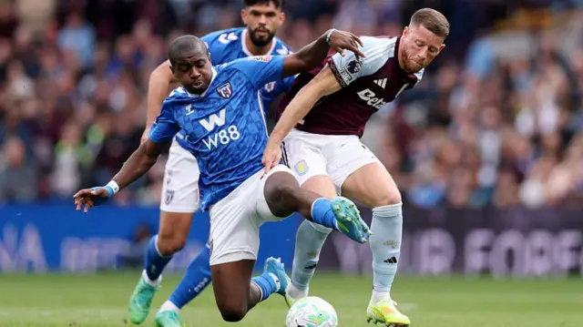 Ross Barkley of Aston Villa is challenged by Noah Sadiki of Sunderland