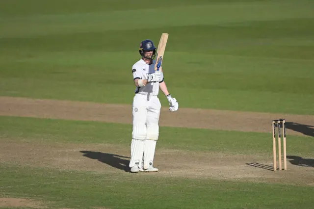 Hampshire batsman Nick Gubbins acknowledging the crowd by raising his bat after reaching a half-century.