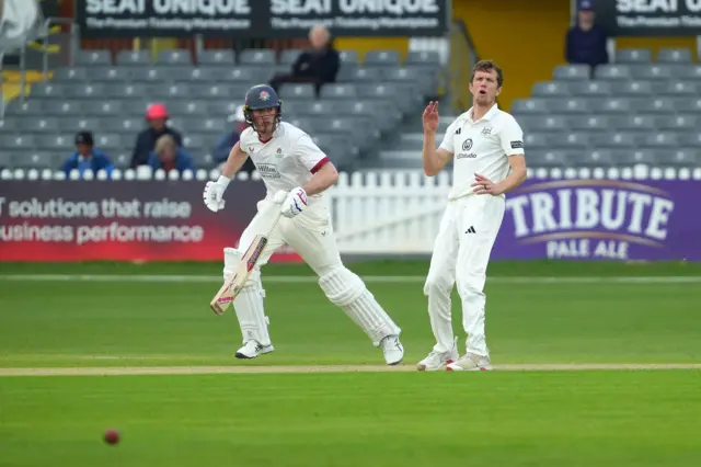 Gloucestershire's Will Williams and a Lancashire batter reacting to a shot