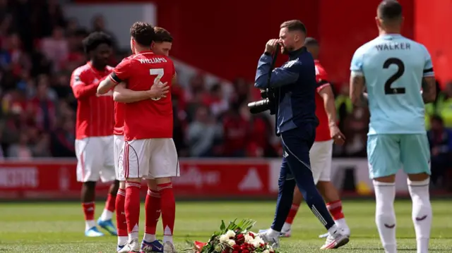 Elliot Anderson of Nottingham Forest lays a wreath as a tribute in memory of Helen Anderson, his Mother,
