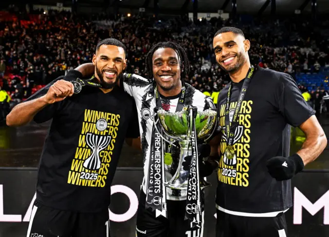 St Mirren's Jonah Ayunga, Dan Nlundulu and Mikael Mandron celebrate with the Premier Sports Cup Trophy during a Premier Sports Cup Final match between St Mirren and Celtic at Barclays Hampden, on December 14, 2025, in Glasgow, Scotland.