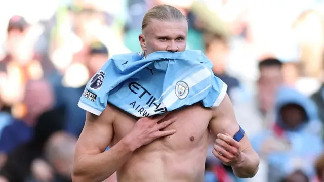 : Erling Haaland of Manchester City reacts after his shirt was ripped by Gabriel of Arsenal