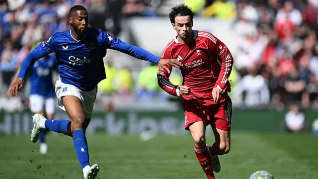 Curtis Jones of Liverpool is challenged by Beto of Everton