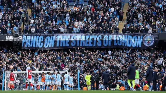 Manchester City fans display a banner which reads 'Panic on the streets of London'