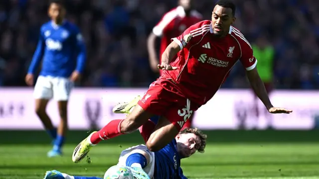 Ryan Gravenberch of Liverpool is challenged by James Garner of Everton