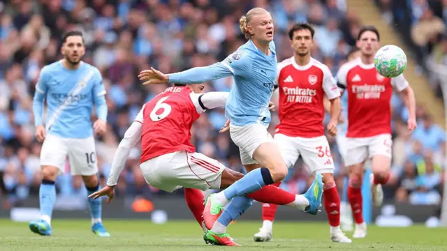 Erling Haaland of Manchester City is tackled by Gabriel Magalhaes of Arsenal
