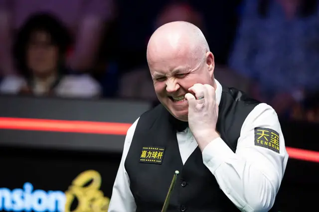 John Higgins bits his nails