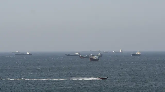Around eight cargo ships pictured in the sea