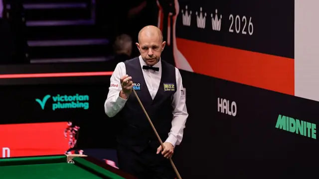 Barry Hawkins chalks his cue at the Crucible
