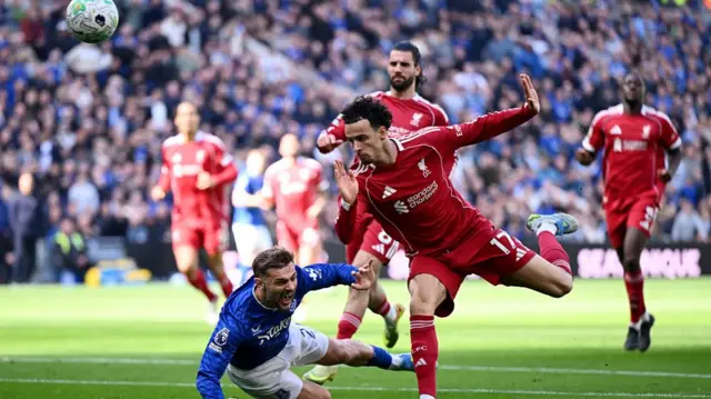 Kiernan Dewsbury-Hall of Everton is challenged by Curtis Jones of Liverpool