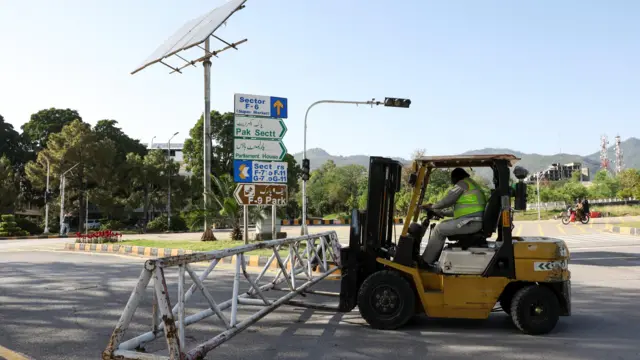 A worker puts up a barrier in Pakistan
