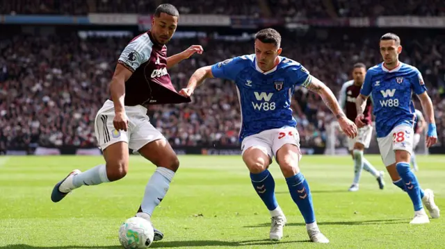 Youri Tielemans of Aston Villa has his shirt pulled by Granit Xhaka of Sunderland