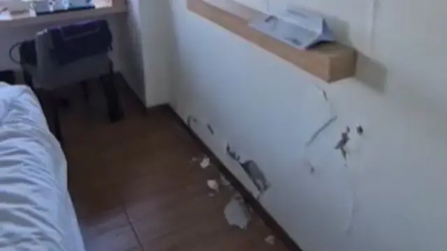 Cracks on the wall inside one of the hotel rooms