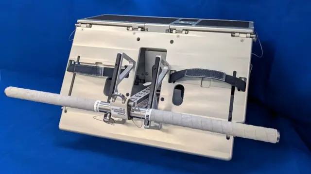 A file image of the flywheel exercise machine against a blue background
