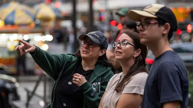 People in New York paused to watch the launch on screens