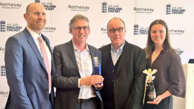 (L-R) Alex Hoad, BBC Local Digital Sports Editor Steve Marshall, Paul Grunill and Grace Ballinger receive the award and champagne on behalf of the entire BBC Sport Online cricket team