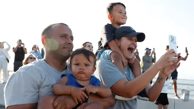 People gather on the day of the launch of the next-generation Moon rocket