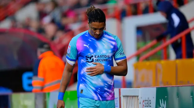 A photo of Sean Clare looking down as he exits the pitch for Leyton Orient