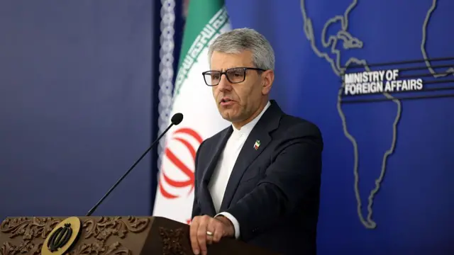 Esmail Baghaei, Iran's foreign ministry spokesperson, stood at a podium speaking