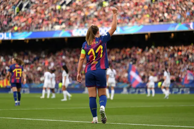 Alexia salutes the crowd as she walks back to kick off after scoring