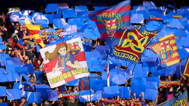 Fans raise cards for a tifo pre match