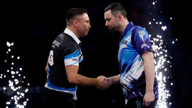 Luke Humphries shakes hands with Gerwyn Price during their quarter-final