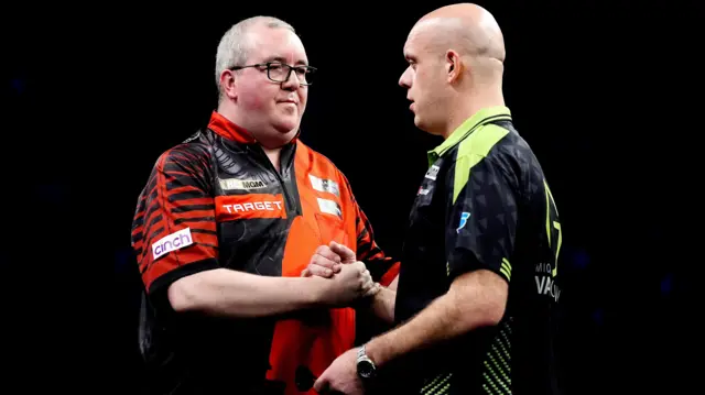 England's Stephen Bunting (left) celebrates winning his match against Netherlands' Michael van Gerwen on night nine of the BetMGM Premier League 2026 at the AO Arena, Manchester