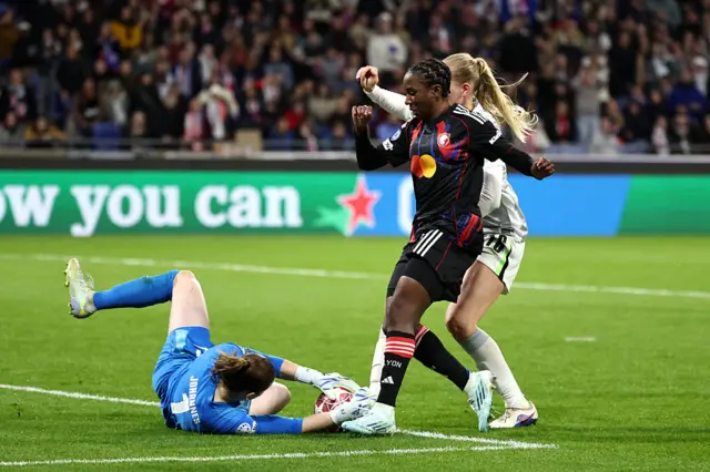 Vicki Becho of OL Lyonnes is challenged by Stina Johannes of VfL Wolfsburg while under pressure from Camilla Kuver