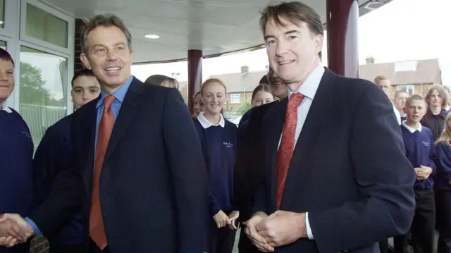 Then-Prime Minister Tony Blair with Peter Mandelson in 2001. They are walking past a group of pupils on a visit to a school in Hartlepool.
