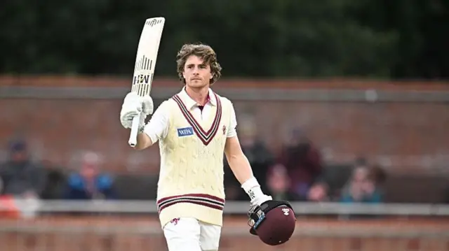 Tom Abell raising his bat for Somerset.