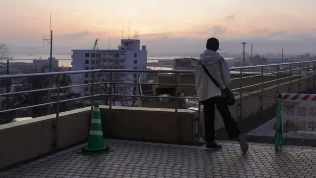 A person stood on the roof of a building