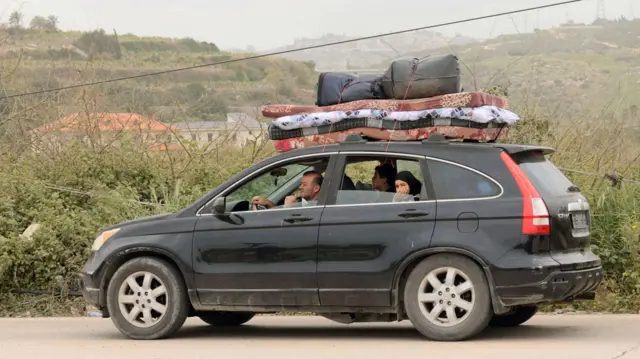 A Lebanese family returning to their home after the ceasefire began