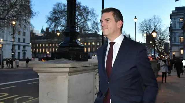 Olly Robbins stands in the street in Westminster