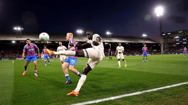 El Hadji Malick Diouf of West Ham United crosses the ball while under pressure from Will Hughes of Crystal Palace