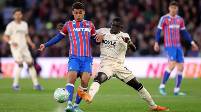 : Brennan Johnson of Crystal Palace is challenged by El Hadji Malick Diouf of West Ham United