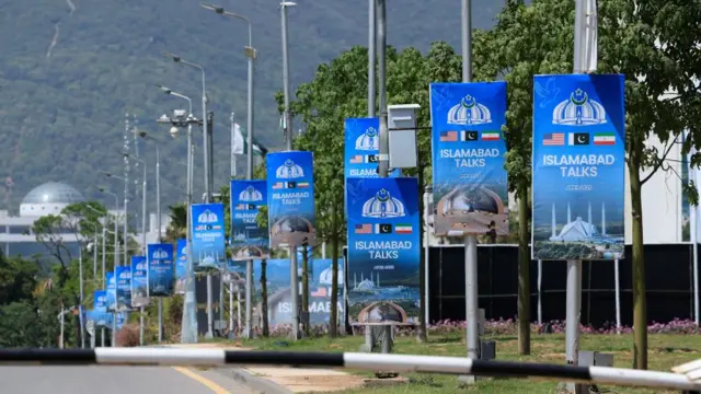 Posters which say 'ISLAMABAD TALKS' with the US, Pakistani and Iranian flags attached to several lamp posts