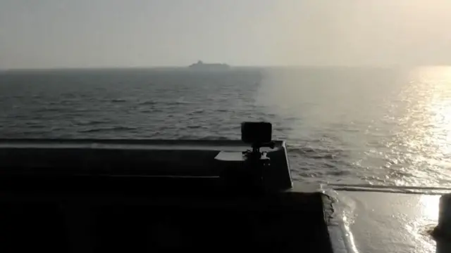 A still image from footage released by the US miluitary, showing the USS Spruance firing at Iranian-flagged cargo ship Touska