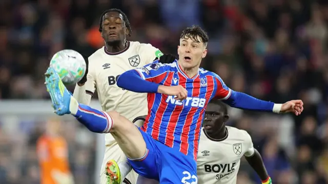 Crystal Palace's Jorgen Strand Larsen and West Ham United's Axel Disasi compete for the ball