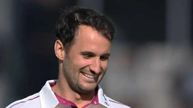 Somerset bowler Lewis Gregory smiling.